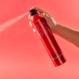 SexyHair Big Spray & Play travel-size next to passport, compact TSA-friendly styling on the go benefit