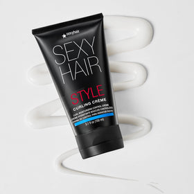 SexyHair curling crème texture close-up on fingertip, highlights moisturizing finish