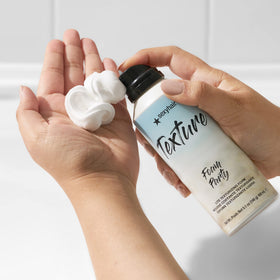 SexyHair foam dispensed on hand highlighting airy foam texture and control