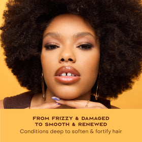 Shea Moisture 13 oz size next to hand to show scale and travel-friendly use