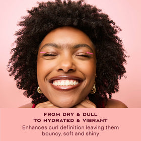 SheaMoisture applying cream to curly hair for defined, frizz-free curls