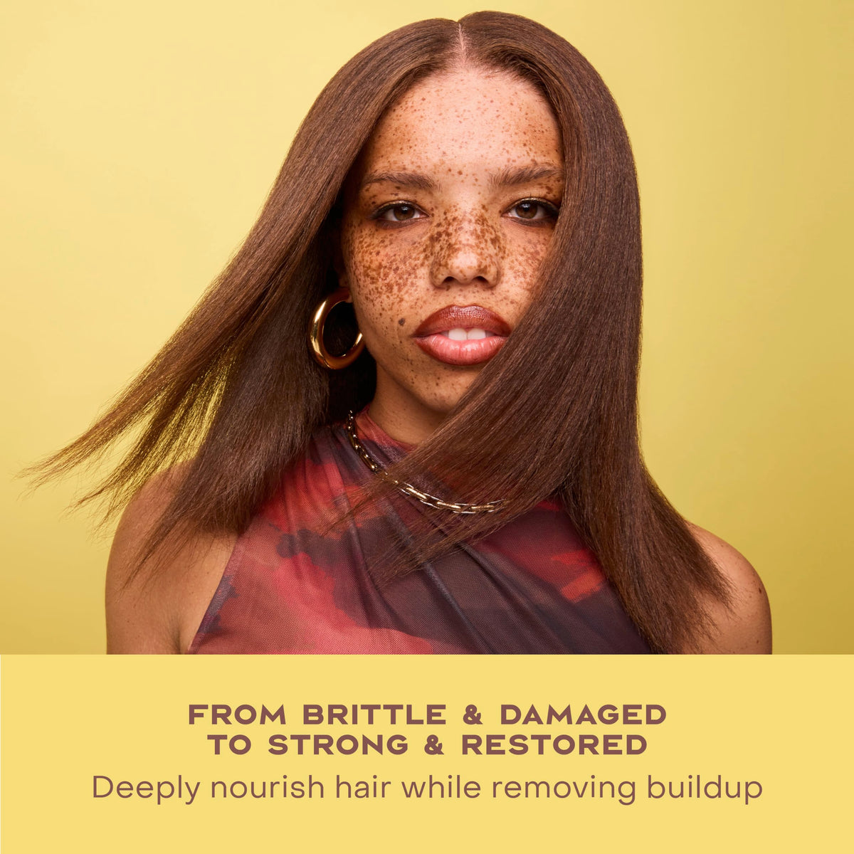 SheaMoisture bottle staged with shea butter and castor oil ingredients