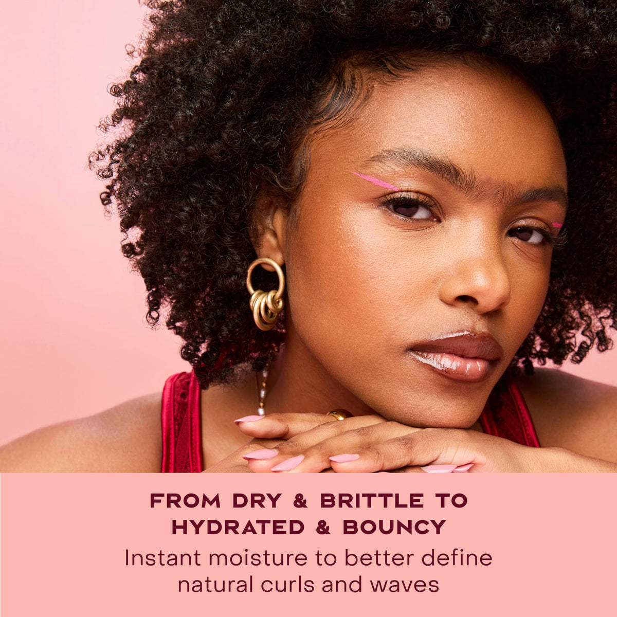 SheaMoisture being applied to curly hair in shower for frizz control benefit