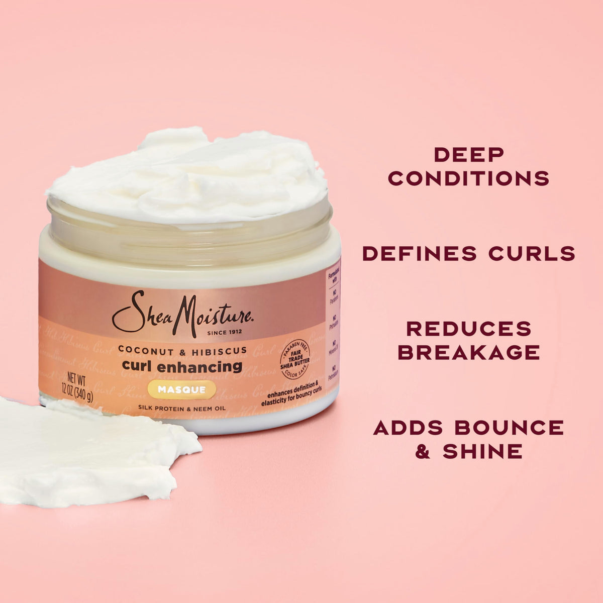 SheaMoisture jar beside coconut and hibiscus highlighting natural ingredients