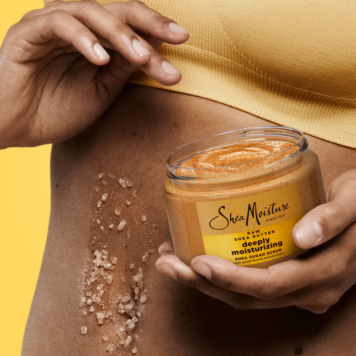 SheaMoisture 12 oz jar next to hand showing product size and practical use