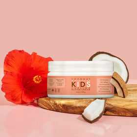 SheaMoisture jar beside child's hand showing 6 oz size and travel-ready benefit
