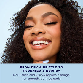 SheaMoisture mousse being applied to damp hair to demonstrate easy styling benefit