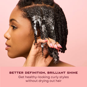 Shea Moisture 7.5 oz canister next to a hand for size perspective and travel convenience
