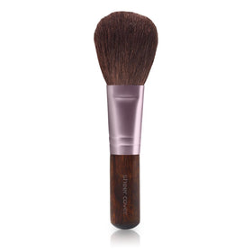 Sheer Cover compact in hand to show scale and travel-friendly design