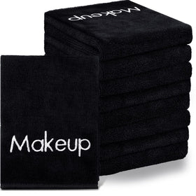 Shimeyao black towel stack showing bulk pack and neat edges for reliable supply