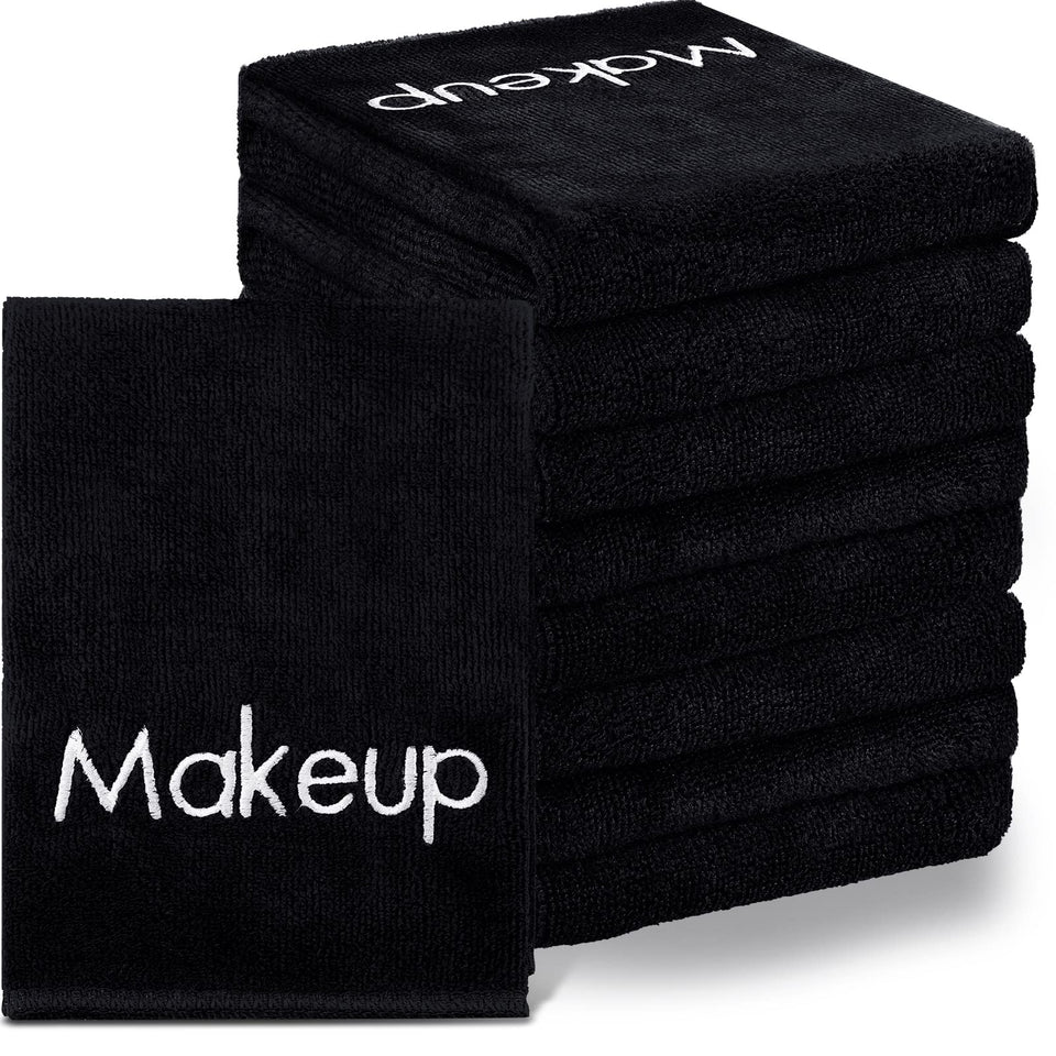 Shimeyao black towel stack showing bulk pack and neat edges for reliable supply