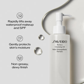 Hand applying Shiseido oil to face demonstrating effective makeup melting