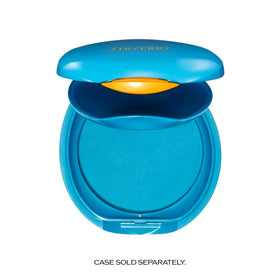 Person applying Shiseido compact outdoors, demonstrating SPF protection and natural finish
