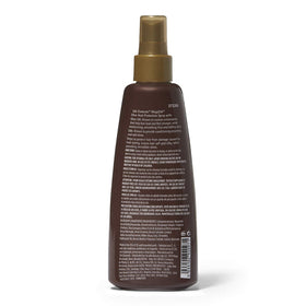 Silk Elements spray being applied from hand to hair, demonstrates easy heat protection