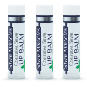 Person applying Silver Miracles lip balm tube to lips outdoors demonstrating portable hydration benefit