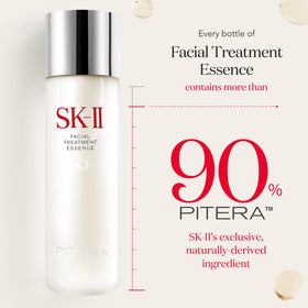 hands applying SK-II essence to palms to premix and press into skin