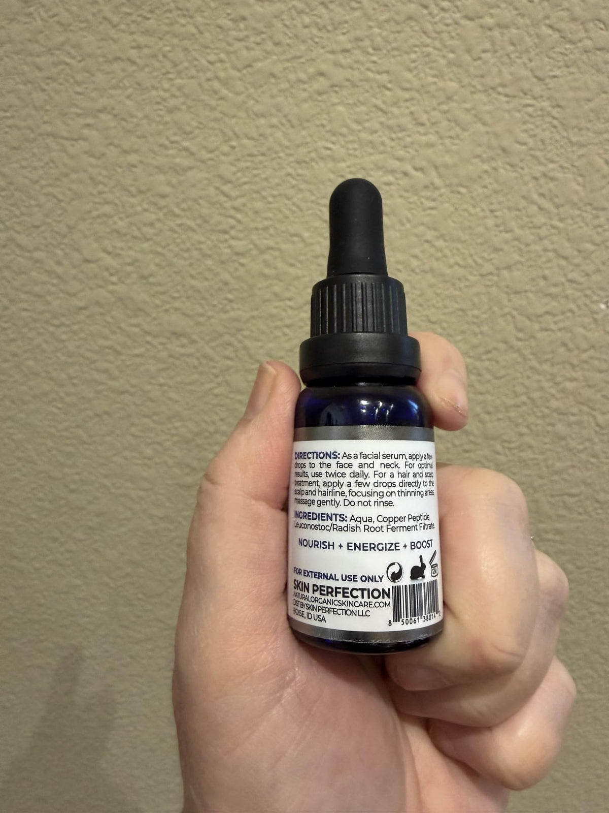 Skin Perfection blue glass bottle detail emphasizing light-protective packaging and stability