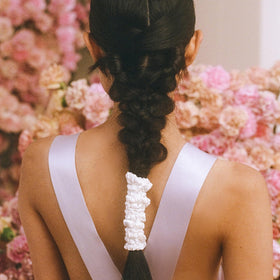 Slip scrunchie wrapped on dark hair demonstrating crease-free finish