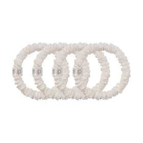 Slip scrunchie holding a low bun to show secure non-damaging hold