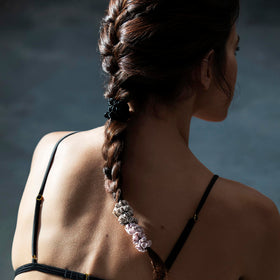 SLIP scrunchies held in hand demonstrating slim size and portability benefit