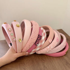 sluxa pink headband next to ruler for scale showing true size and fit
