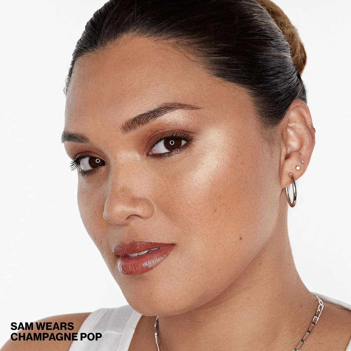 Smashbox BECCA brush applying highlight to cheekbone for sculpted radiance