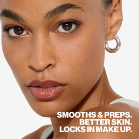 Smashbox primer held in hand to show travel-size scale and convenient portability for touchups