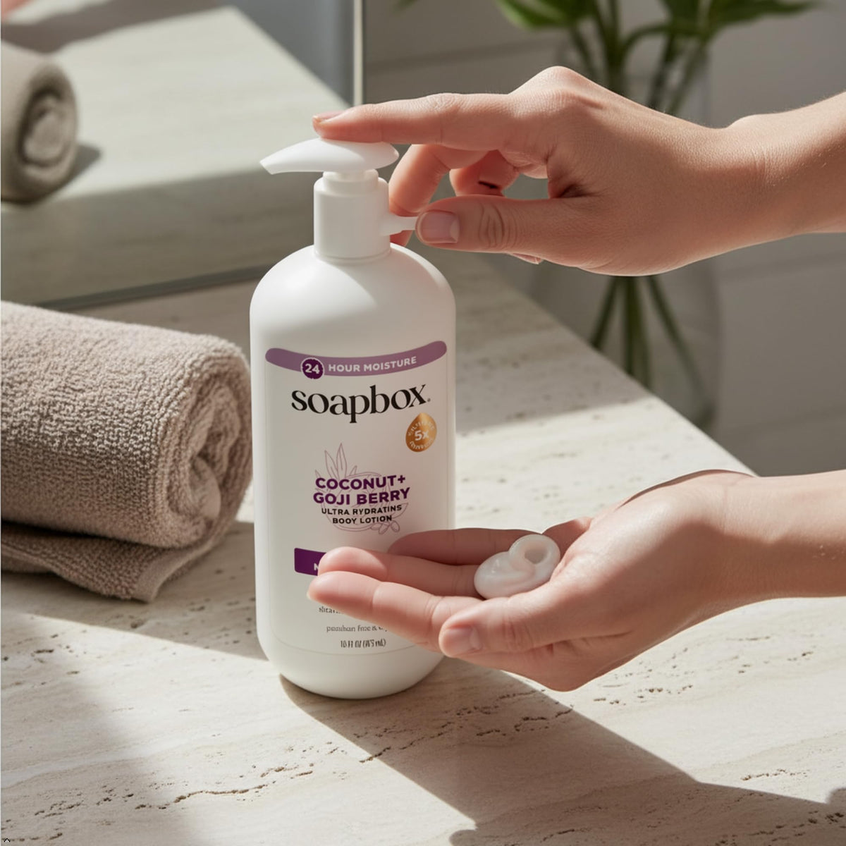 Soapbox bottle next to hand for size comparison and travel-friendly convenience