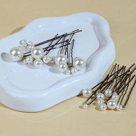SOLENY flatlay with pins, veil, and flowers showing complementary wedding styling