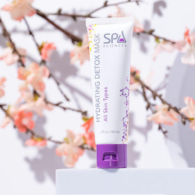SPA SCIENCES mask being spread on cheek to demonstrate even application and calming effect