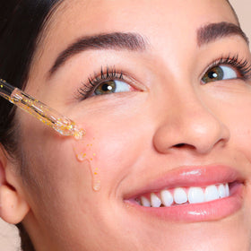 SpaLife close-up of 24k gold flakes suspended in serum for luminous glow