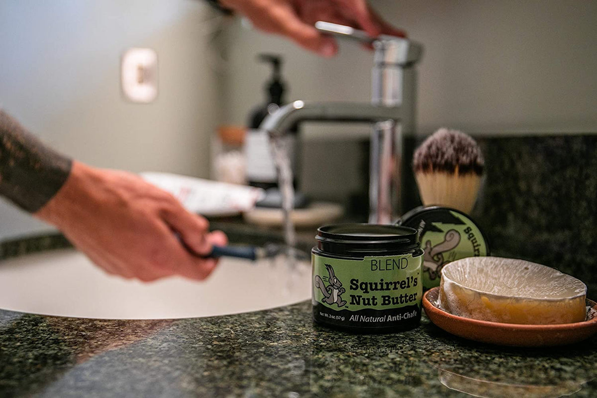 Squirrel's Nut Butter being applied to a runner's thigh demonstrating friction prevention