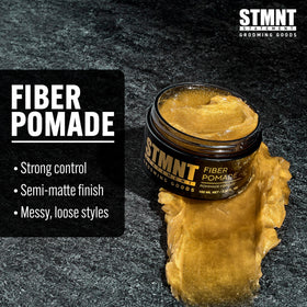 STMNT fiber pomade spread on hands demonstrating easy warming and application
