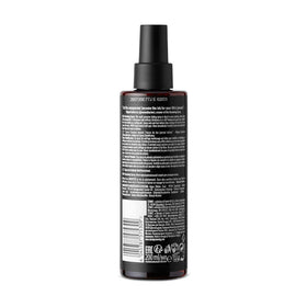 STMNT grooming spray held in hand demonstrates compact 6.7 oz size and portability