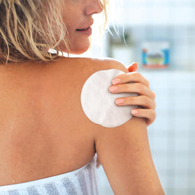 Stridex XL application on cheek showing dual-textured pad reducing surface oil