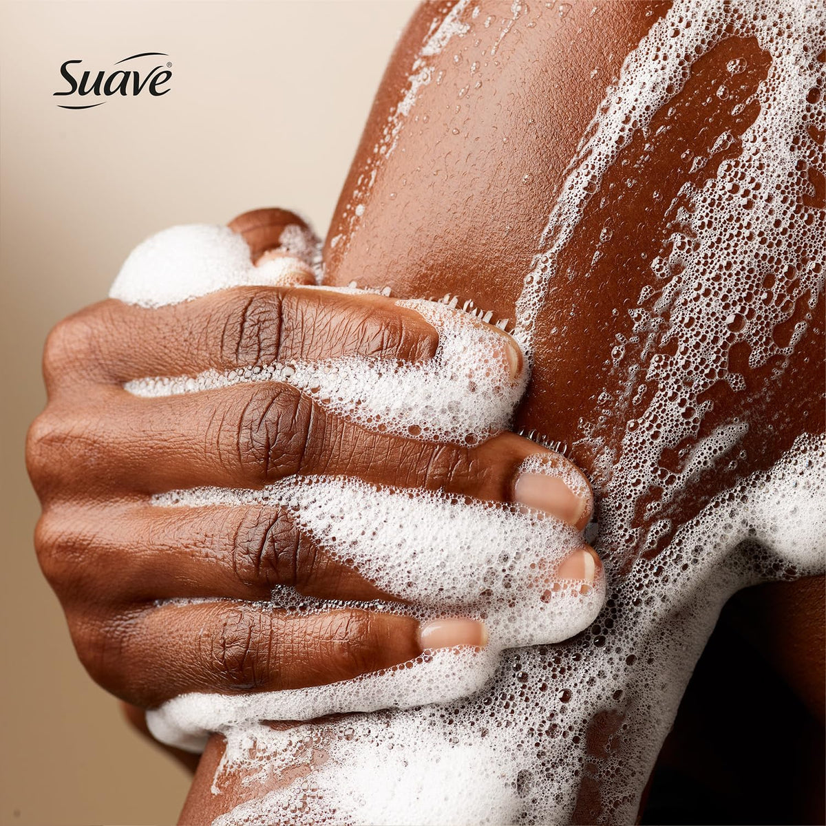 Hand holding a 30 oz Suave bottle to show scale and long-lasting use