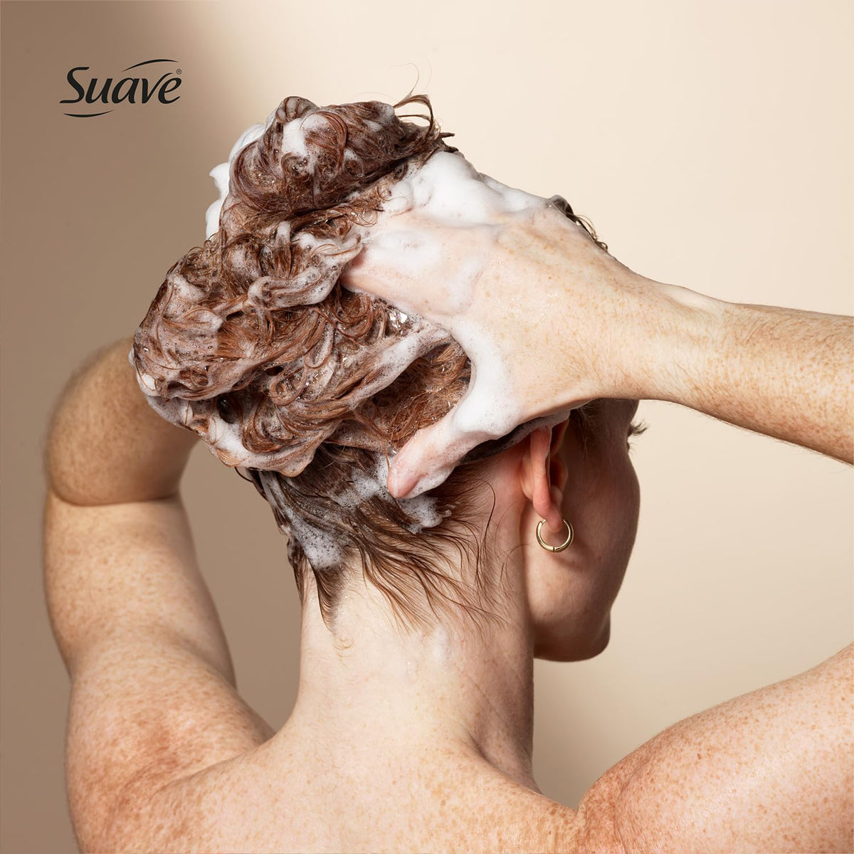 Suave clarifying shampoo bottle held to show 22.5 oz size and family convenience