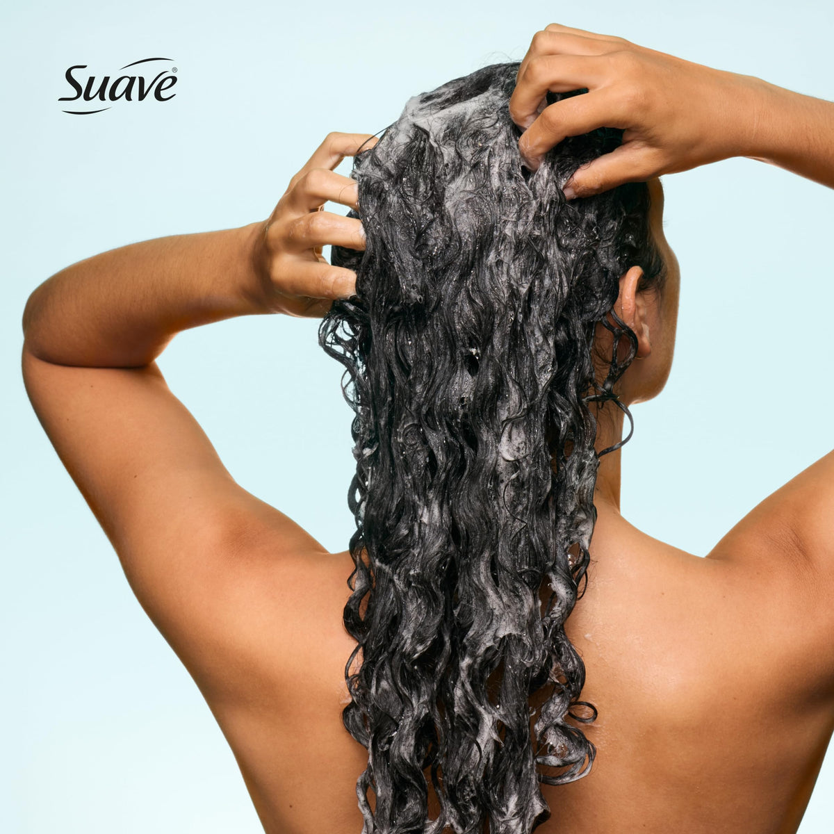 Lathered Suave shampoo in hand illustrating gentle cleansing and foam