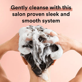 Person lathering hair with Suave for visible frizz control benefits