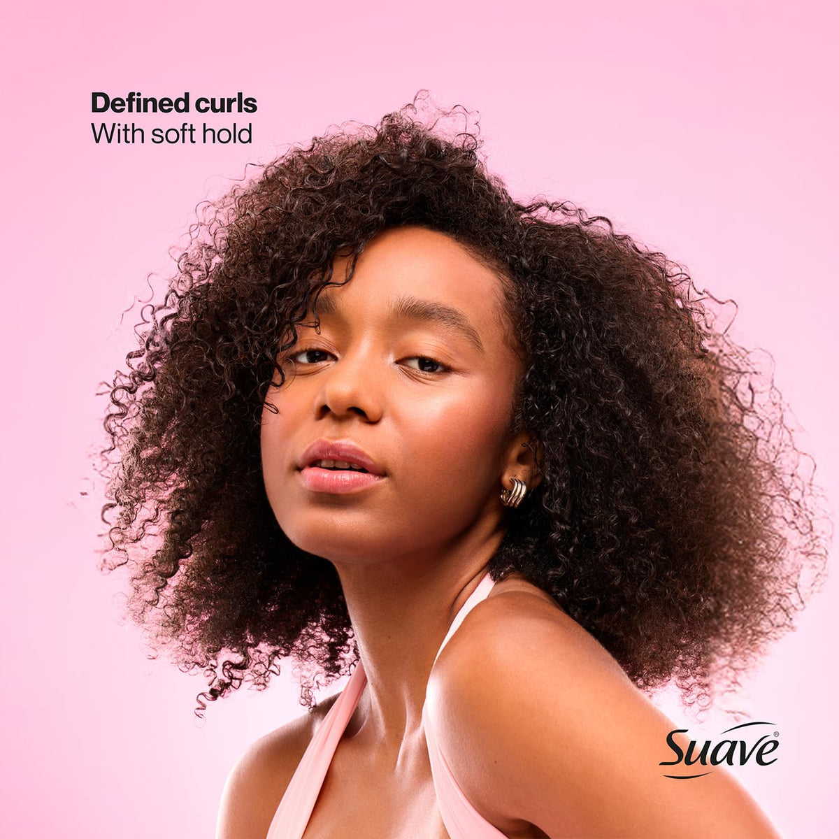 Model with beach curls styled using Suave whipped mousse for natural volume