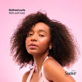 Model with beach curls styled using Suave whipped mousse for natural volume