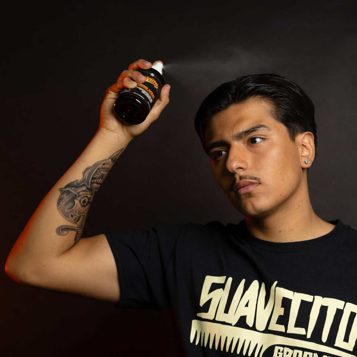 Suavecito hairspray used by barber to set pomade style effectively