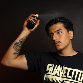 Suavecito hairspray used by barber to set pomade style effectively