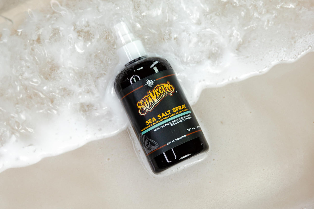 Male model using Suavecito spray to create tousled beachy volume