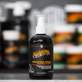 Suavecito bottle in hand showing 8 oz scale and portability benefit