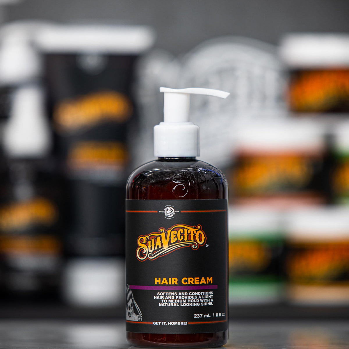 Suavecito bottle beside hand for scale showing convenient 8 oz size benefit