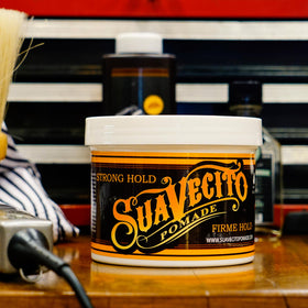 Suavecito tub on barbershop shelf indicating professional salon readiness