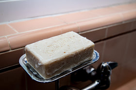 Suavecito lathering in shower illustrating cleansing and gentle exfoliation