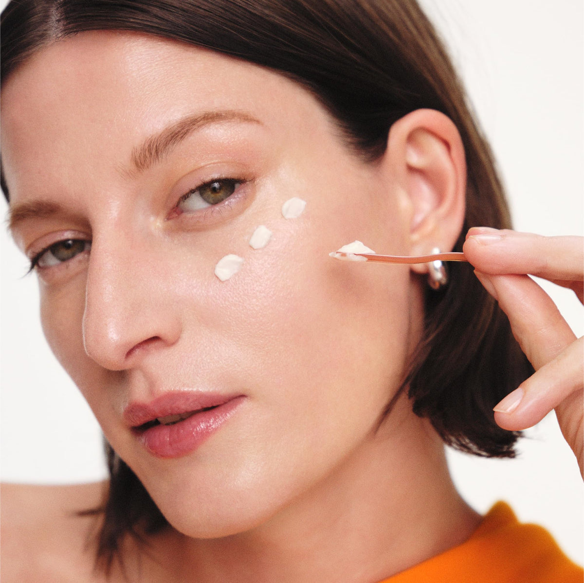 Sulwhasoo applying cream with fingertips to under-eye area for targeted firming
