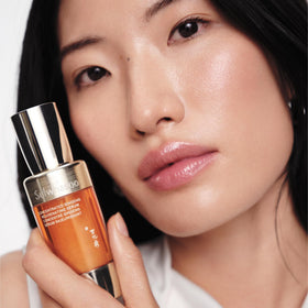 Sulwhasoo serum on fingertips showing lightweight texture for easy absorption